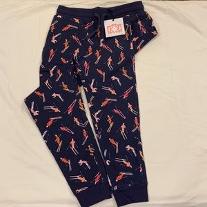 Dark blue pants with a skiers print. Never been worn new with tags size small.